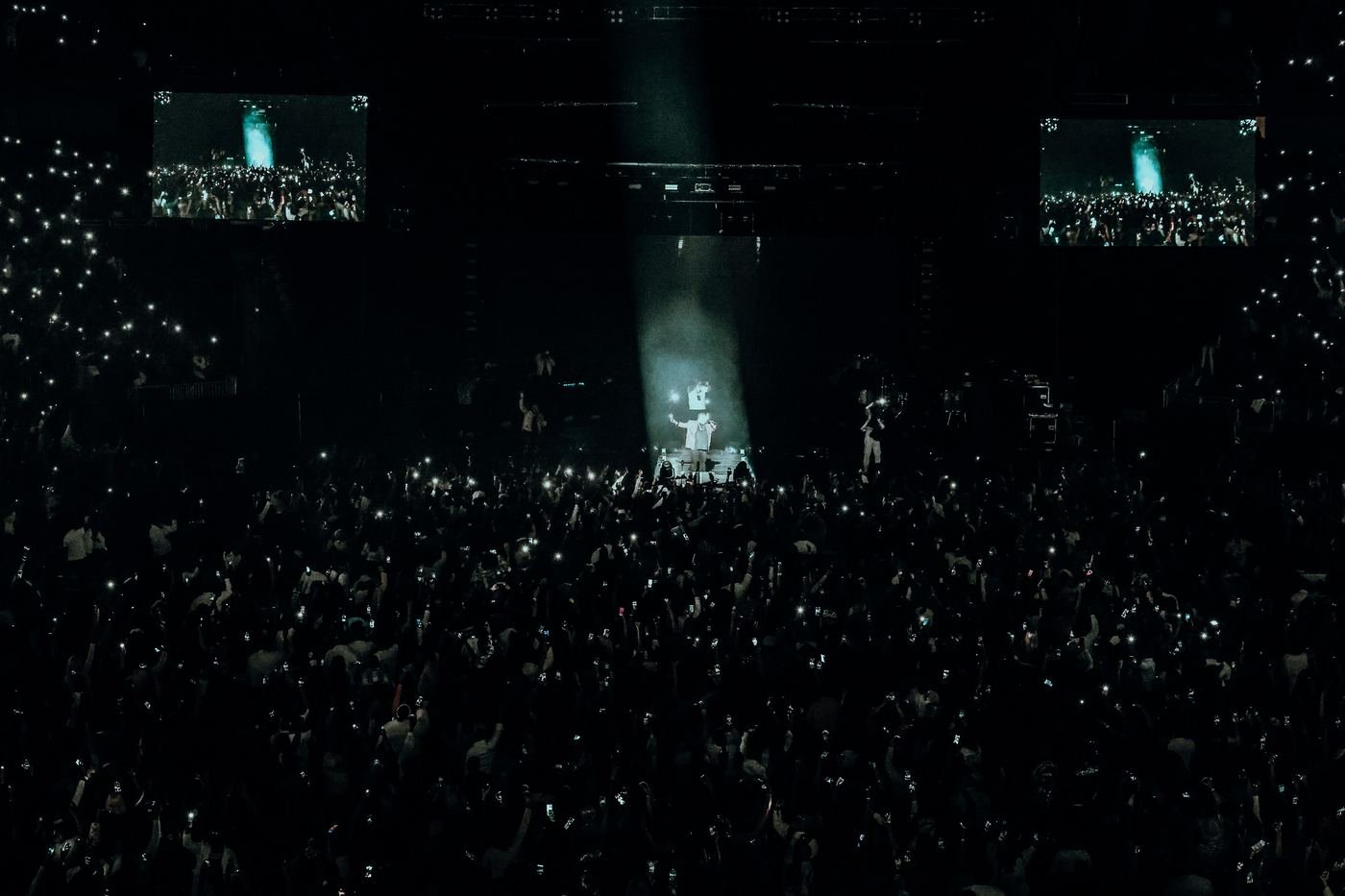 Aerial view of Mickael Guirand performing for a packed arena crowd